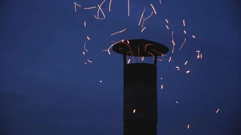 Chimney on dark blue sky background spitting sparks on a windy night Stock Footage 122823278
