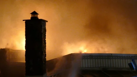 Chimney is one of last piece of structure standing after fiery incident Stock Footage 129987015