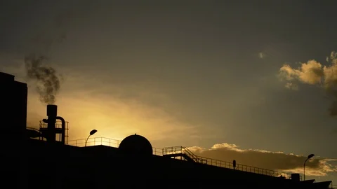 Chimney or stack in plant industrial exhaling pollution smoke at sunset Stock Footage 69947852