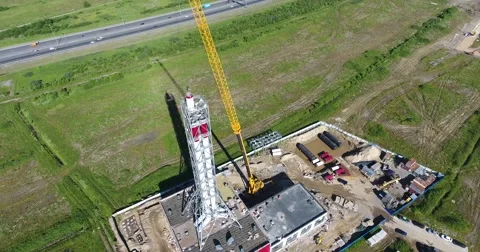 Chimney pipe construction aerial, the crane lifts the pipe segment flying around Video stock 68787432