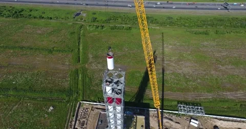 Chimney pipe construction, the crane lifts the pipe segment. Aerial shot Vidéo 68787146
