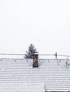 Chimney on a rooftop in winter Stock Photos
