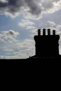Chimney Silhouette with Gathering Clouds Stock Photos