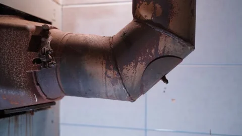 Chimney from a solid fuel heating boiler close-up. Rusty heating parts of the Stock Footage 229863611