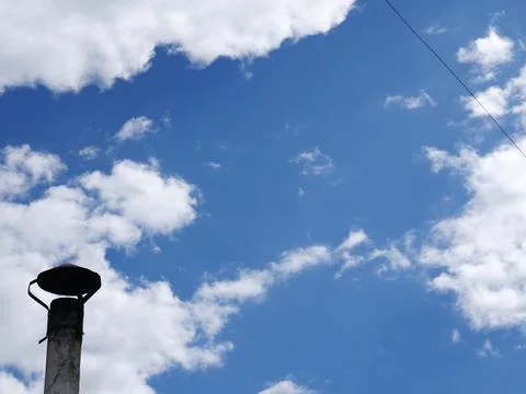 A chimney stack and a blue sky with white clouds. Space for the text Stock Photos