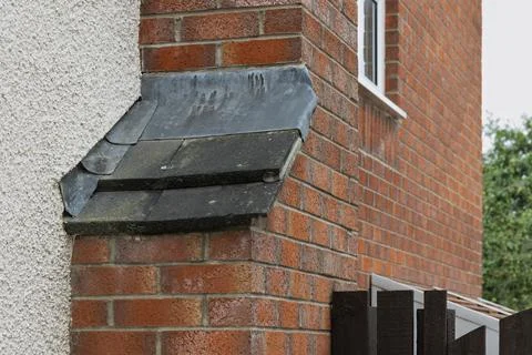 Chimney stack on exterior brick wall of residential house Stock Photos