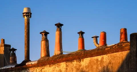 Chimney Stacks at Sunset on Rooftop Stock Photos