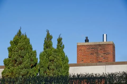 Chimney Surrounded by Green Trees Under Blue Sky Stock Photos