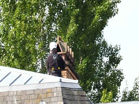 Chimney sweeper working hard Stock Footage