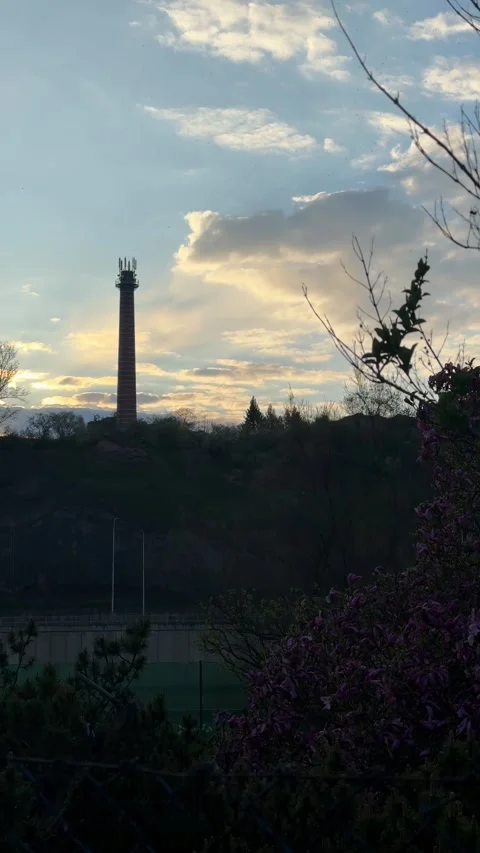 Chimney, a tall brick structure featuring telecommunication antenna, stands on a Stock Footage 333776709