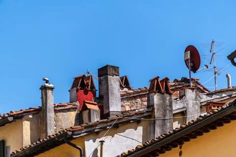 Chimneys And Antennas On A Roof Stock Photos