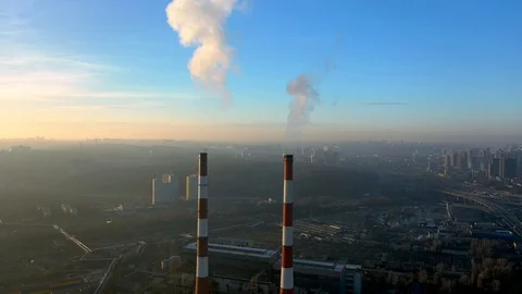 Chimneys of an industrial enterprise top view, at sunset time. Stockbeeldmateriaal 128203653