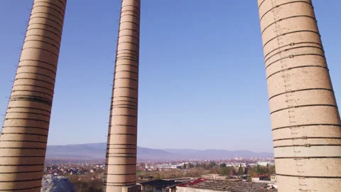 Chimneys of an old abandoned factory with camera movement right next to the Stock Footage 330686910