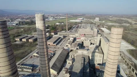 Chimneys of an old abandoned factory from a circular close-up flight Stock Footage 330471619