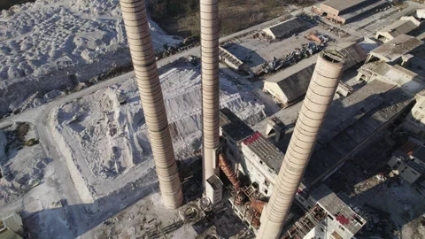 Chimneys of an old abandoned factory with an elevator moving camera from the air Stock Footage 330686761
