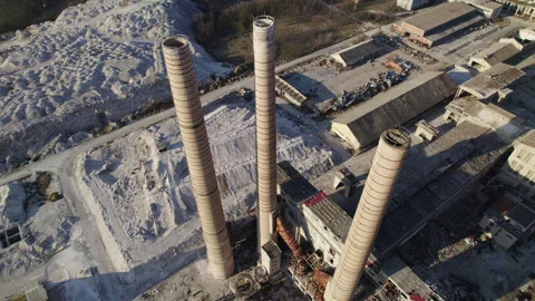 Chimneys of an old abandoned factory with vertical camera movement from the air Stock Footage 330686973