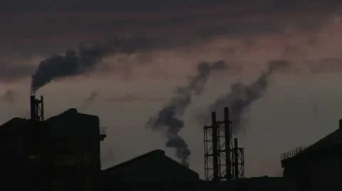 Chimneys pumping back smoke into atmosphere Stockbeeldmateriaal 12595812