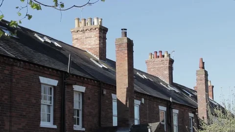 Chimneys, windows and slate tiled roof tops of traditional Victorian houses 動画素材 73513577