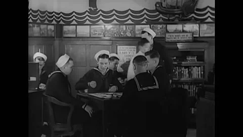 CHINA - 1939 - US Navy sailors stationed in China play backgammon. Stockbeeldmateriaal 259378317