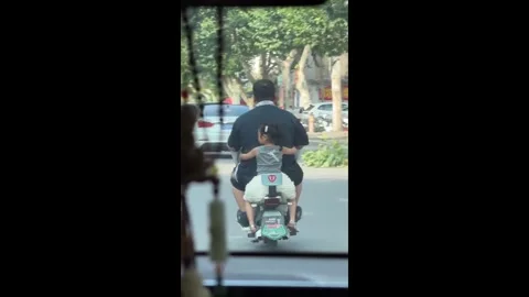 China: Amusing size contrast between Chinese father and daughter caught o... Stock Footage 341319558