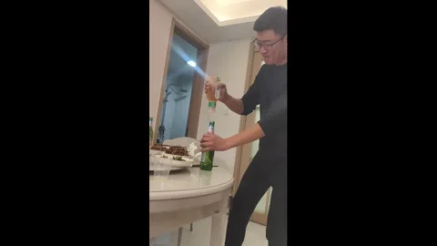China: Bottle-opening trick backfires, spilling drink in Hebei, China Stock Footage 322554895