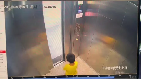 China: Boy trapped in elevator after stick gets caught in door in Henan, ... Stock Footage 334549597