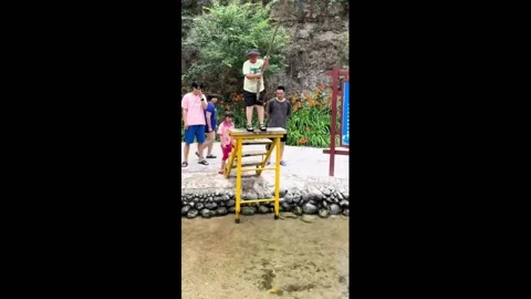 China: Boy's funny fall while swinging on a rope in China Stock Footage 295867007