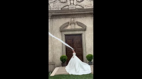 China: Bride's veil gets swept away by gust of wind during wedding photos... Stock Footage 337522374