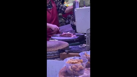 China: Butcher in China uses automatic meat-chopping machine at market Stock Footage 322720919