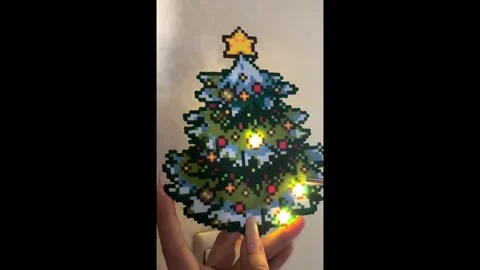 China: Chinese creator builds a light-up pixel-bead Christmas tree using ... Stock Footage 323896391