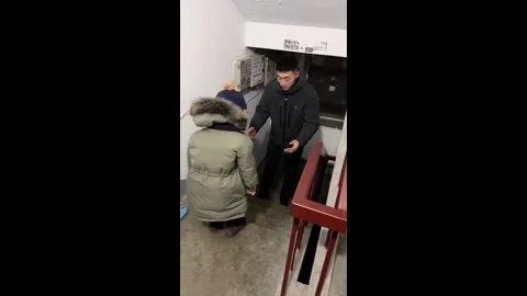 China: Chinese dads mistimed catch caused his son to fall in stairwell Stock Footage 332889413