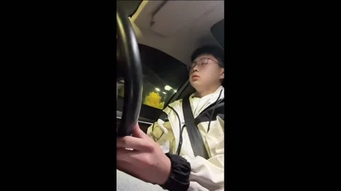 China: Chinese man combats drowsy driving with cash trick Stock Footage 293475920
