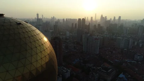China cities - drone flight of golden hotel tower and skyline Wuhan at sunset Stock Footage