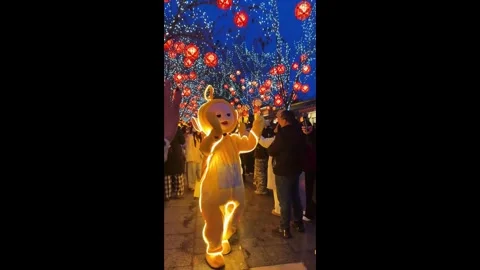 China: Costume characters parade through illuminated night park in China Video stock 333083942