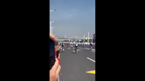 China: Cyclists crash after curve at Tangbo Lake race in Tianjin, China Stock Footage 334699488