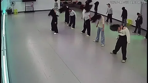 China: Dance instructor faints during class, students continue in Liaonin... Video stock 321742865