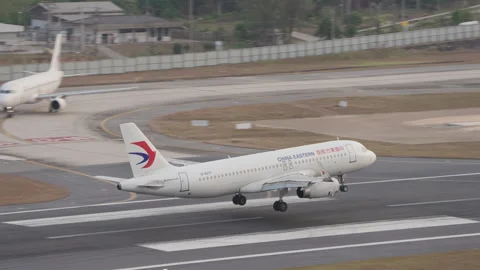 China Eastern Airbus A320 Passenger Airplane Landing at Phuket Airport, Sunset Stock Footage 242860315