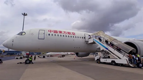 China Eastern Airlines passenger jet with boarding passenger Stock Footage 319273067
