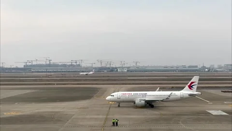 China Eastern Airlines passenger jet departing from the terminal at Pudong Stock Footage 331106317