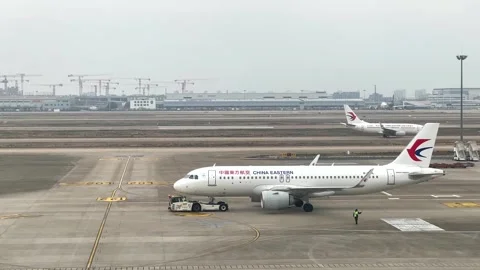 China Eastern Airlines passenger jet departing from the terminal at Pudong Stock Footage 331106765