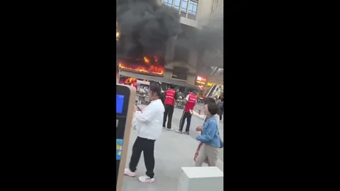 China: Fire breaks out in building causing panic nearby in Shaanxi, China... Stock Footage 334020385