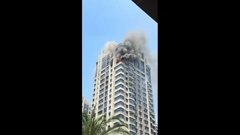 China: Fire breaks out at high-rise residential tower in Zhejiang, China Stock Footage 334783083