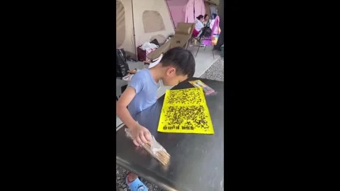 China: Fly trap paper blows into boys face in Anhui, China Video stock 320757754