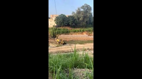 China: Front loader douses flames to save nearby excavator in Guangdong, ... Stock Footage 320671689