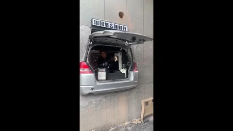 China: Honda hatchback turned into a unique coffee shop implanted in wall... Stock Footage 320618540