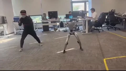 China: Humanoid robot in China accidentally kicked an engineer during a m... Stock Footage 326611830