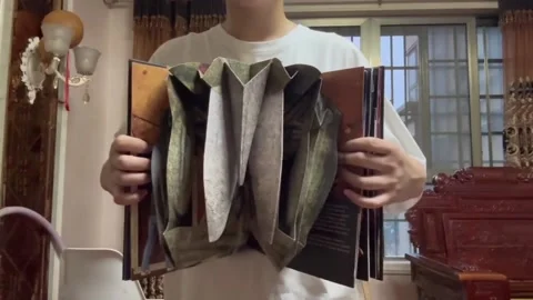 China: Man demonstrates “Stranger Things” pop-up book in Mianyang Stock Footage 282183275