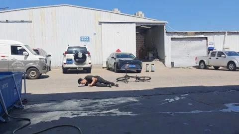 China: Man falls while attempting wheelie on BMX bike in Shandong, China Stock Footage 337212496