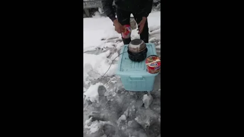 China: Man Has Noodle Pitstop While Stranded On Hunan Highway Due To Snowsto... Stock Footage 280572246
