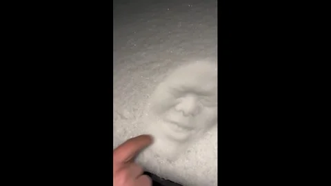 China: Man makes face imprint in snow and laughs at result in Hebei, Chin... Stock Footage 331287975